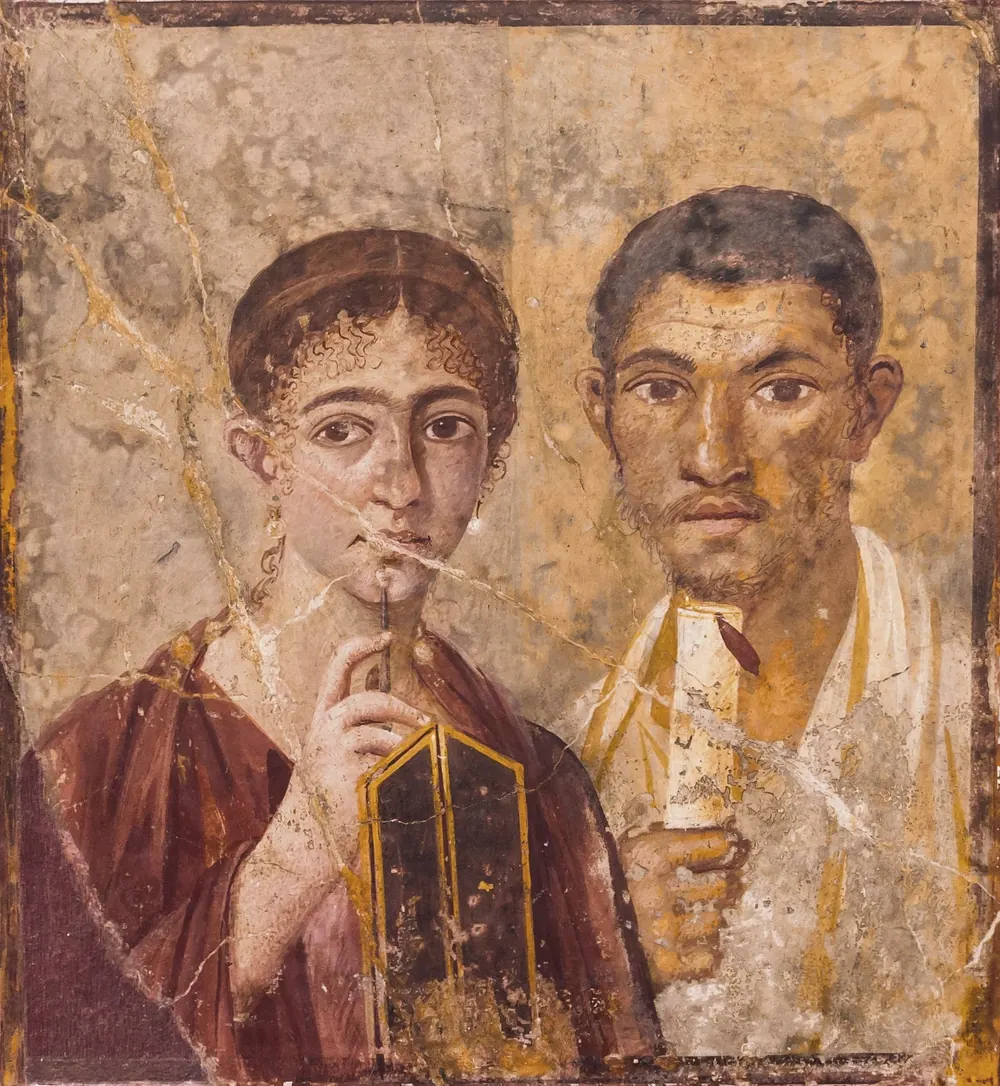 Fresco from Pompeii of a married couple: she holds a wax tablet and stylus, he a scroll